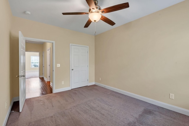 unfurnished bedroom with ceiling fan and carpet floors