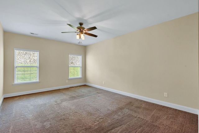 unfurnished room featuring ceiling fan, plenty of natural light, and carpet