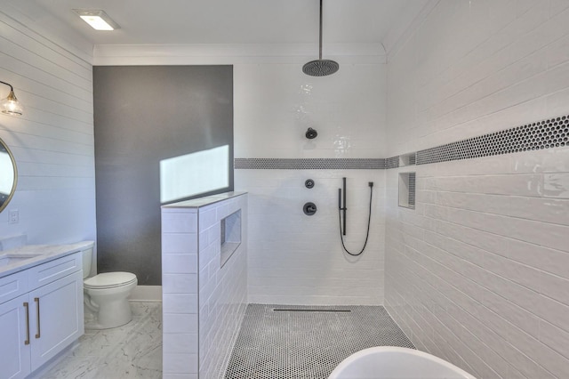 bathroom featuring a tile shower, crown molding, vanity, and toilet