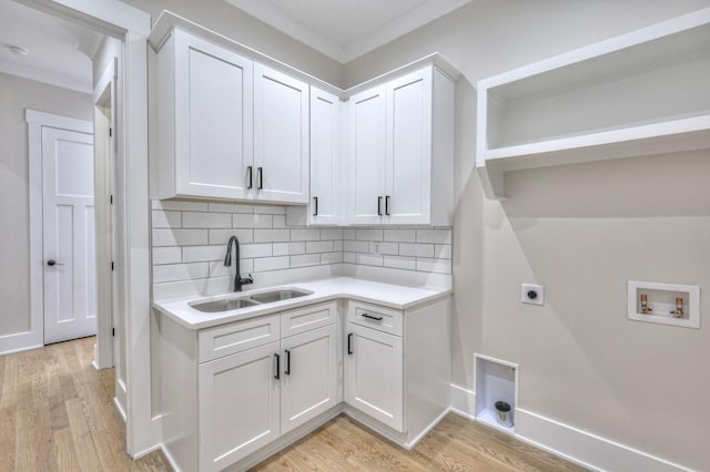 laundry room featuring sink, light hardwood / wood-style flooring, washer hookup, and hookup for an electric dryer