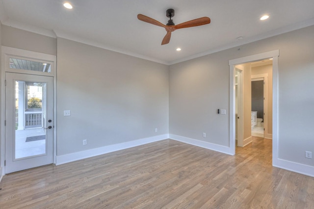 spare room featuring ceiling fan, light hardwood / wood-style floors, and ornamental molding