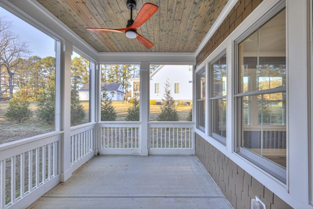 unfurnished sunroom with ceiling fan and wooden ceiling