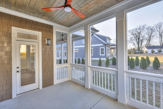 unfurnished sunroom with ceiling fan and wood ceiling