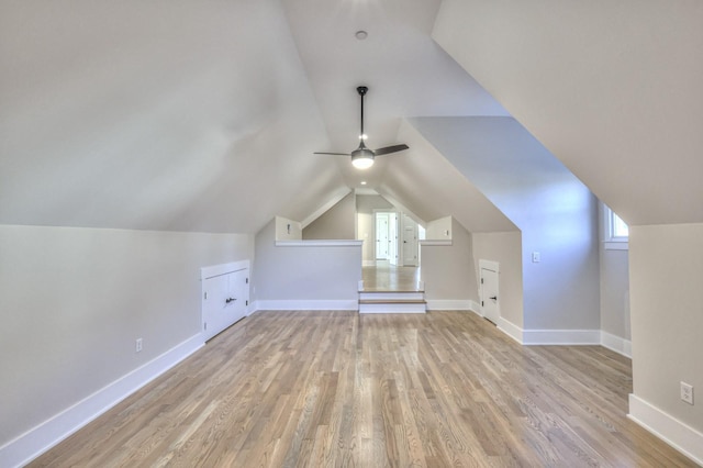 additional living space featuring ceiling fan, vaulted ceiling, and light wood-type flooring