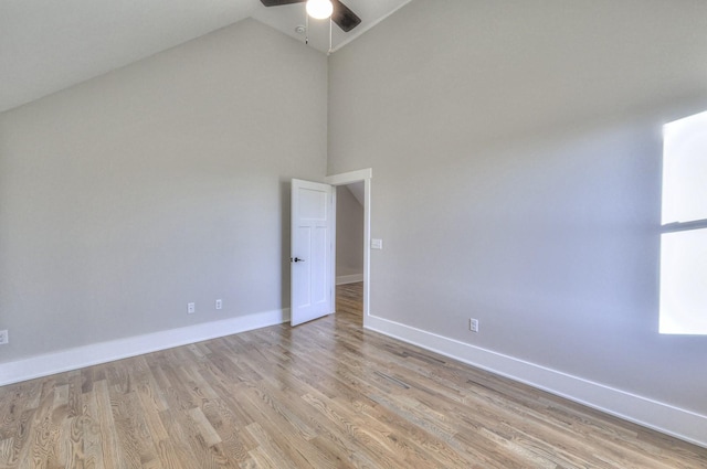 unfurnished room with light hardwood / wood-style floors, high vaulted ceiling, and ceiling fan