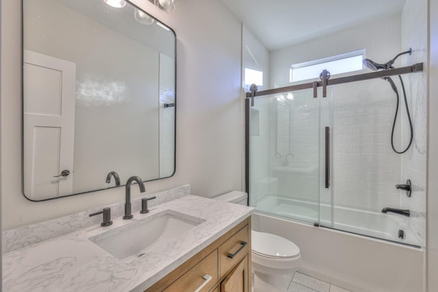 full bathroom with vanity, toilet, and bath / shower combo with glass door