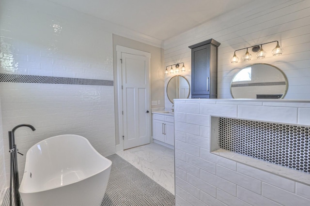 bathroom featuring vanity, a tub to relax in, tile walls, and crown molding