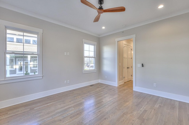 empty room featuring light hardwood / wood-style floors, ceiling fan, and crown molding