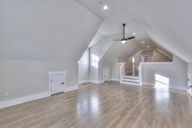 additional living space with ceiling fan, light hardwood / wood-style flooring, and vaulted ceiling