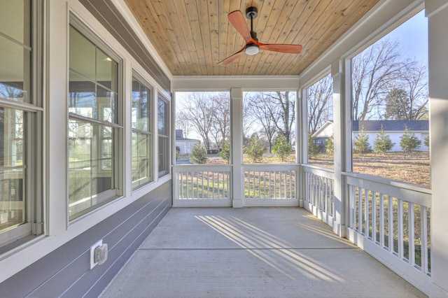 unfurnished sunroom with ceiling fan and wood ceiling