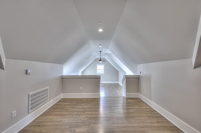 additional living space featuring ceiling fan, wood-type flooring, and lofted ceiling