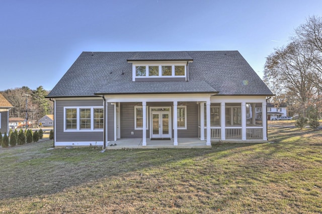 rear view of property featuring a lawn and a patio