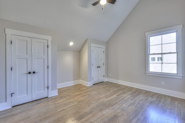 bonus room with light hardwood / wood-style floors, vaulted ceiling, and ceiling fan