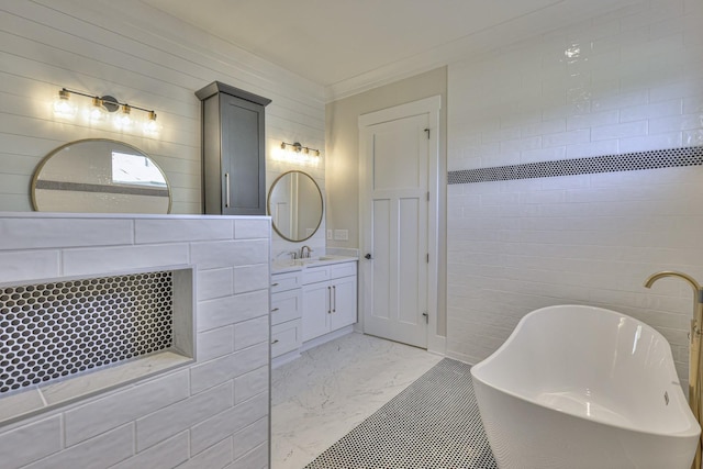 bathroom with vanity, a tub to relax in, and ornamental molding