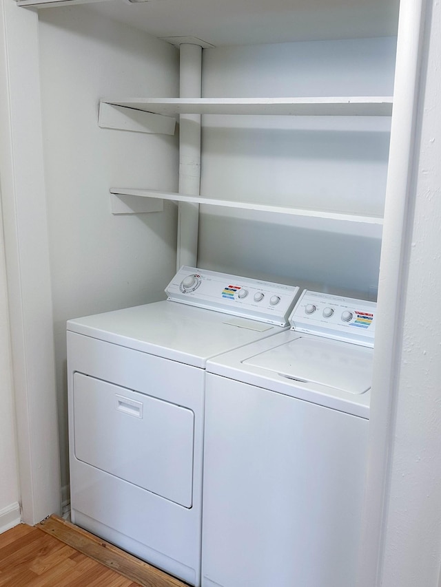 washroom featuring washing machine and dryer and hardwood / wood-style floors