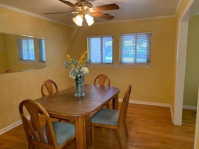 dining area featuring crown molding, ceiling fan, and hardwood / wood-style flooring