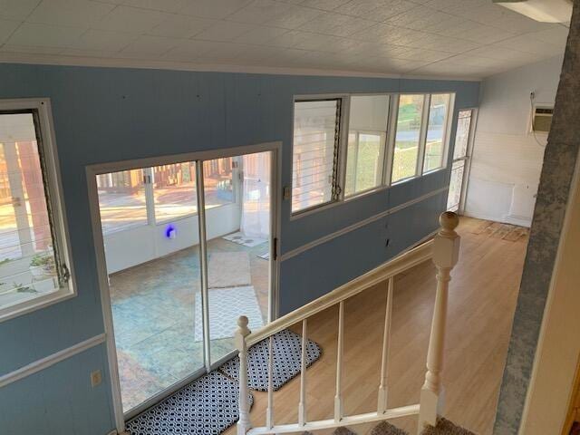 interior space featuring hardwood / wood-style floors and crown molding