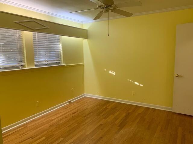 empty room with hardwood / wood-style floors, ceiling fan, and ornamental molding