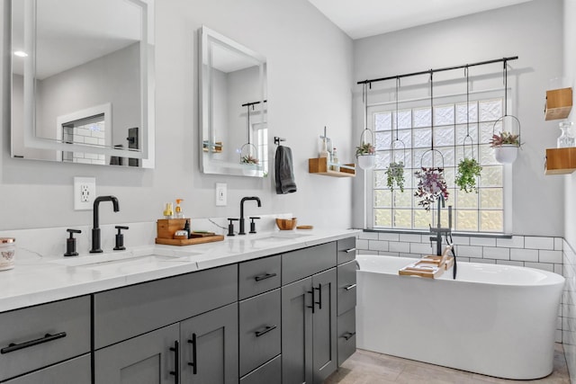 bathroom with a bath and vanity