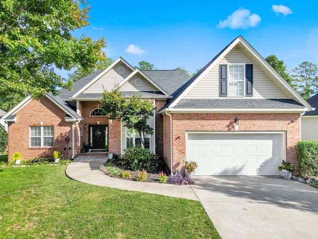traditional home featuring roof with shingles, driveway, a front lawn, brick siding, and a garage