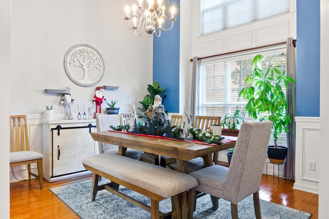 dining space with a chandelier and wood-type flooring