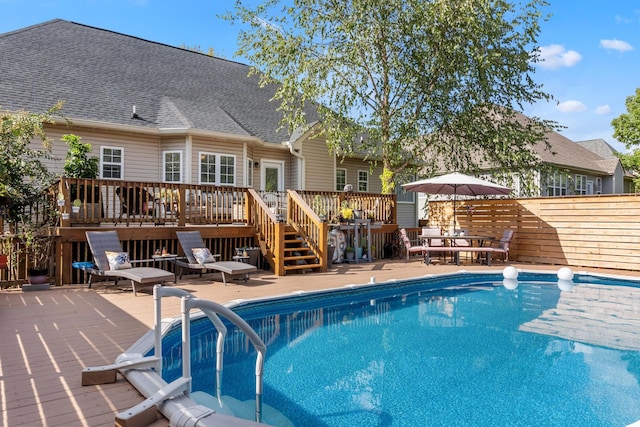 view of swimming pool featuring a wooden deck