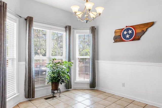 interior space with light tile patterned floors and a notable chandelier