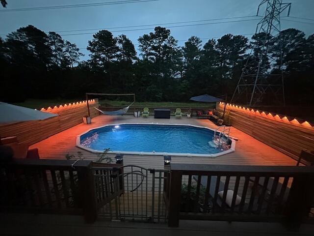 view of pool featuring a wooden deck