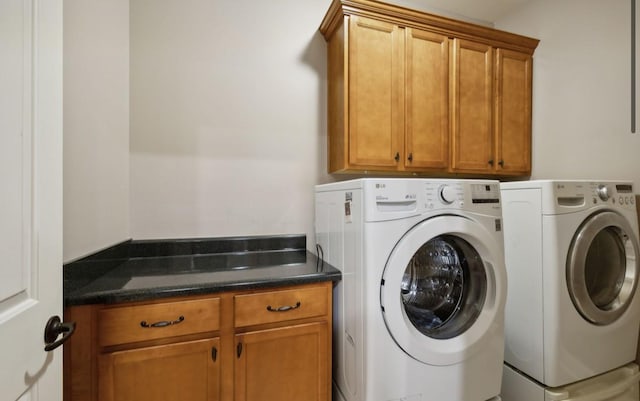 laundry area with cabinets and washer and clothes dryer