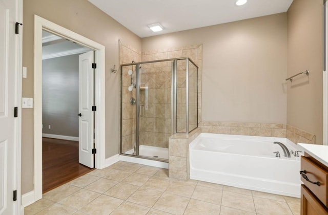 bathroom featuring tile patterned floors, vanity, and independent shower and bath