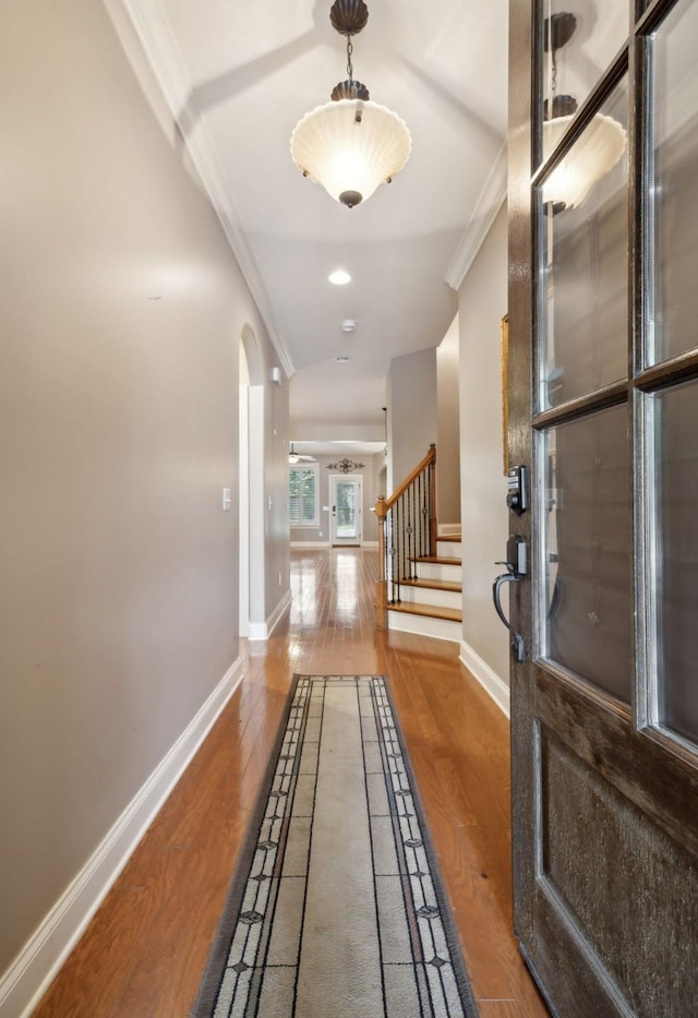 corridor with crown molding and hardwood / wood-style flooring