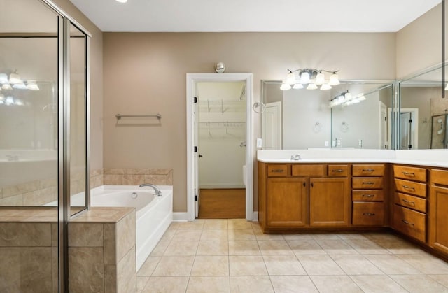 bathroom with plus walk in shower, vanity, and tile patterned floors