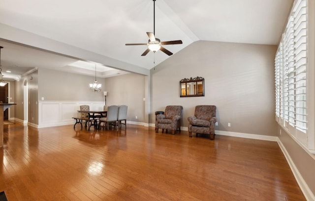 sitting room featuring hardwood / wood-style floors, ceiling fan with notable chandelier, and lofted ceiling