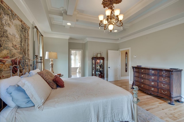 bedroom with crown molding, light wood-type flooring, and an inviting chandelier