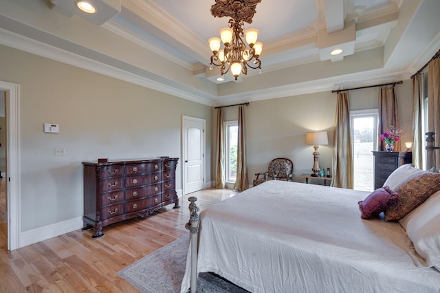 bedroom featuring a chandelier, a raised ceiling, ornamental molding, and multiple windows