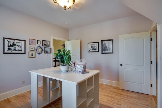 interior space featuring a kitchen breakfast bar, a center island, and light hardwood / wood-style flooring