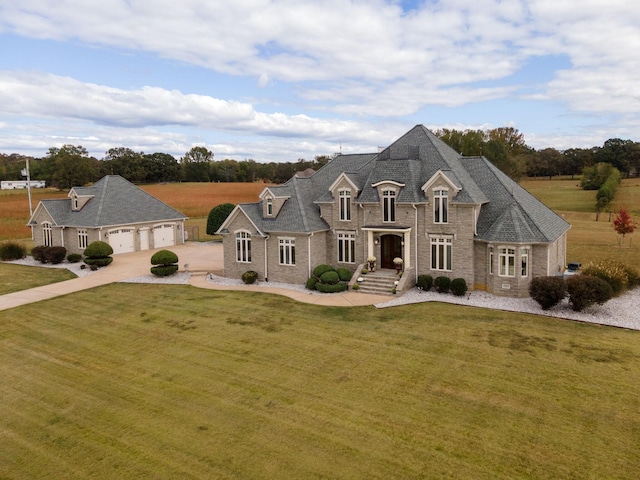 french country inspired facade featuring a front lawn and a garage