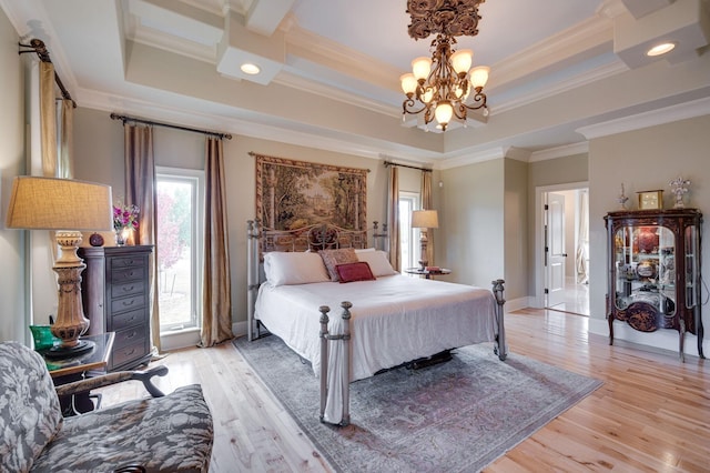 bedroom with a tray ceiling, light hardwood / wood-style flooring, an inviting chandelier, and ornamental molding