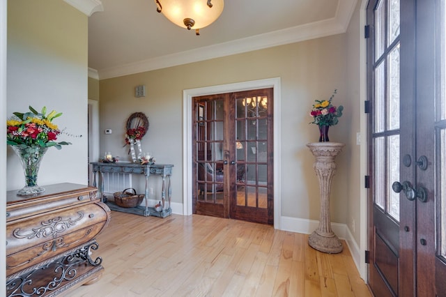 entryway featuring a wealth of natural light, french doors, hardwood / wood-style floors, and ornamental molding