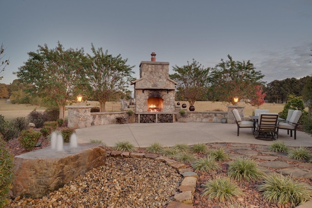 view of patio with an outdoor stone fireplace