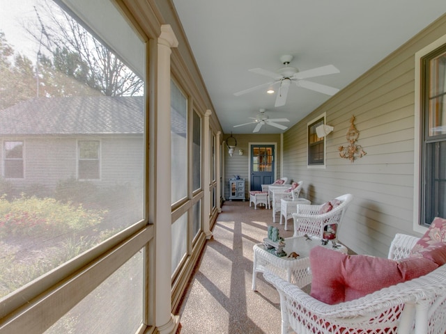 sunroom featuring ceiling fan