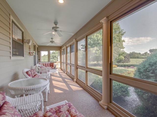 sunroom featuring ceiling fan