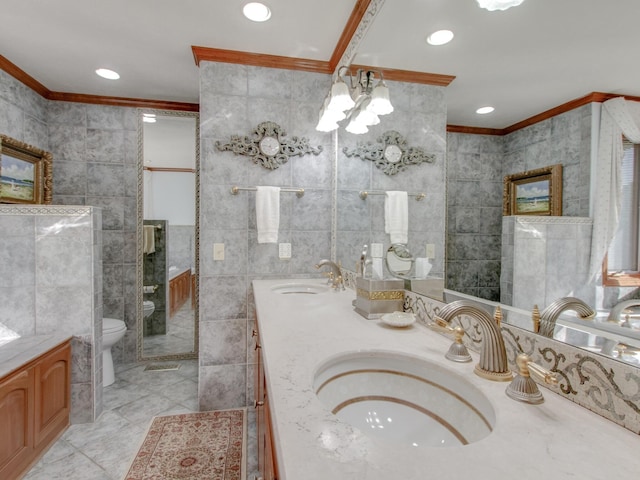 bathroom featuring vanity, toilet, crown molding, and tile walls