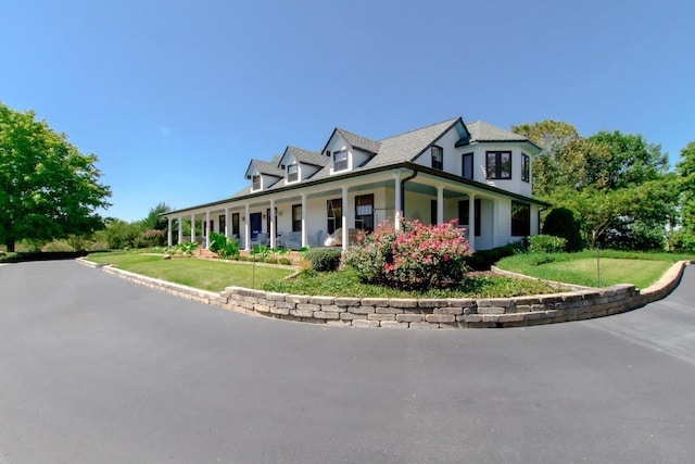 view of front of house with a porch and a front yard