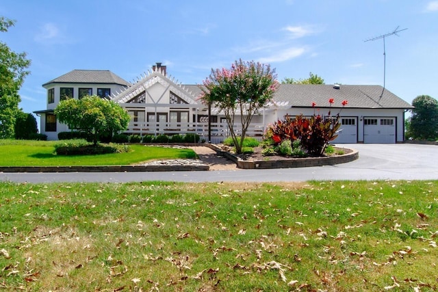 view of front of house with a garage and a front lawn