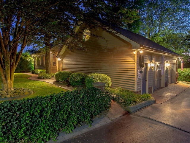 view of side of home featuring a garage