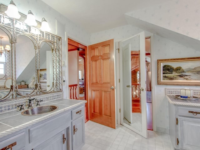 bathroom with vanity and an inviting chandelier