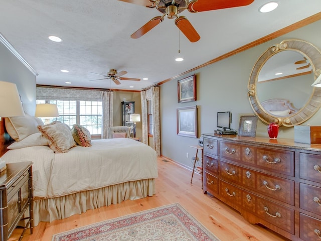 bedroom with ceiling fan, light hardwood / wood-style floors, and ornamental molding