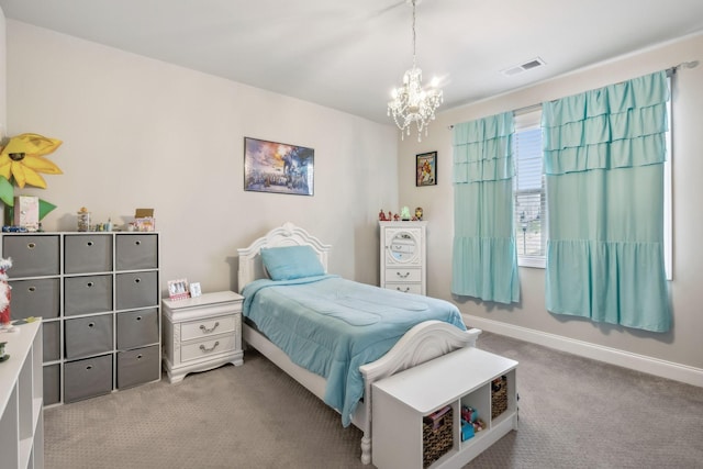 carpeted bedroom featuring an inviting chandelier