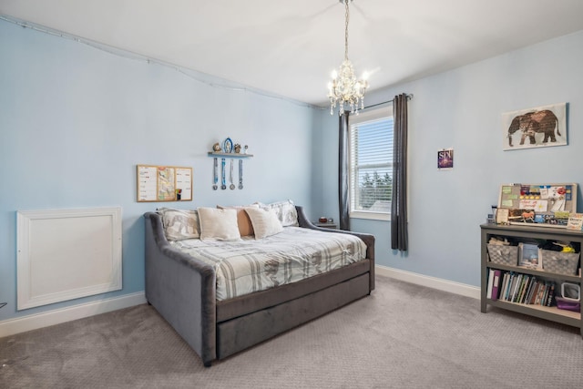 carpeted bedroom featuring an inviting chandelier